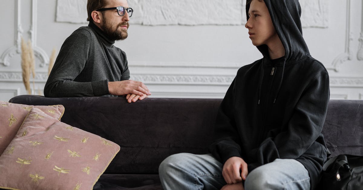 Teenage Boy gives Counselling Sessions in the Bathroom [closed] - Man in Black Jacket Sitting on Brown Couch