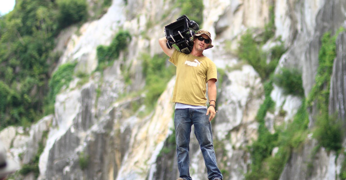The end of the movie The Day Will Come - Man Standing on Rock While Holding Black Case