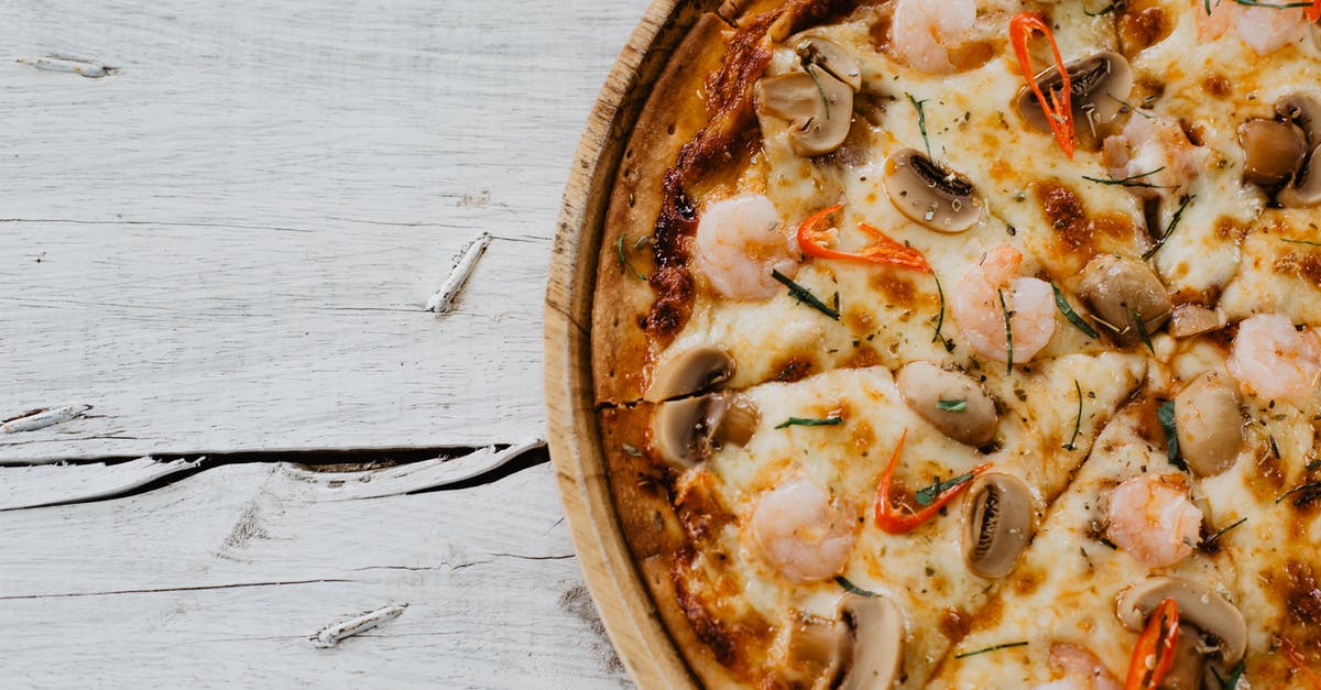 The Italian from Leverage - Appetizing pizza with shrimps and champignon on wooden table