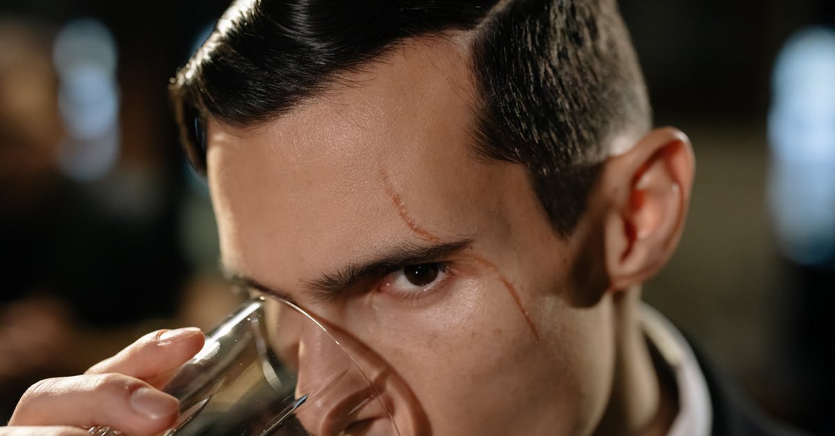 The most roles played by the same actor in a movie? - Close-Up Photo of Man Drinking from Glass of Whiskey