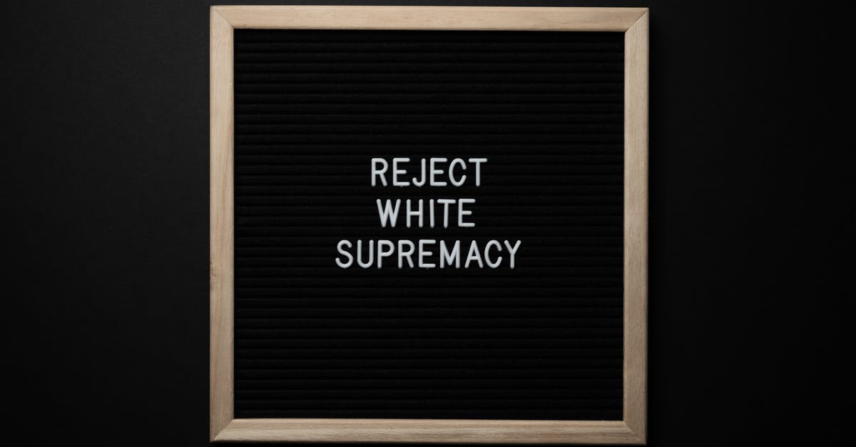 There Will Be Blood title significance - Top view of blackboard with written white REJECT WHITE SUPREMACY words on center on black background
