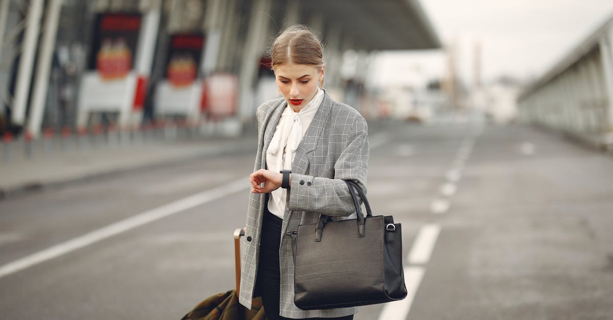 Time and Space Travel? - Worried young businesswoman with suitcase hurrying on flight on urban background