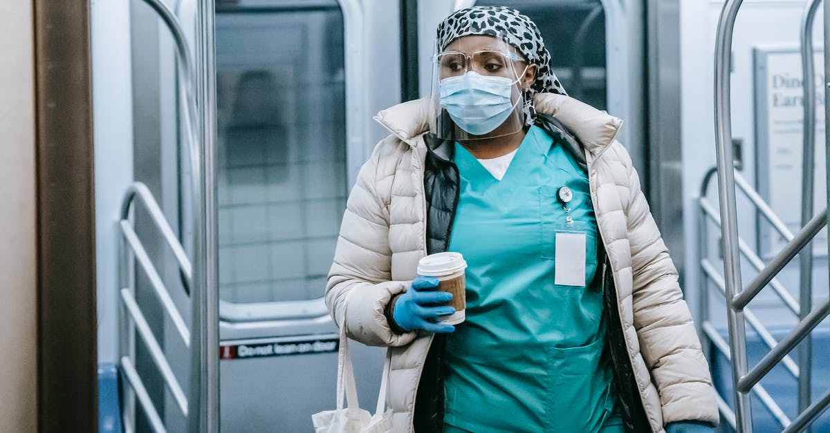 To which railway station did Doug go to leave the city? - Emotionless African American female doctor in uniform and outerwear wearing protective mask and face shield leaving metro train during coronavirus pandemic