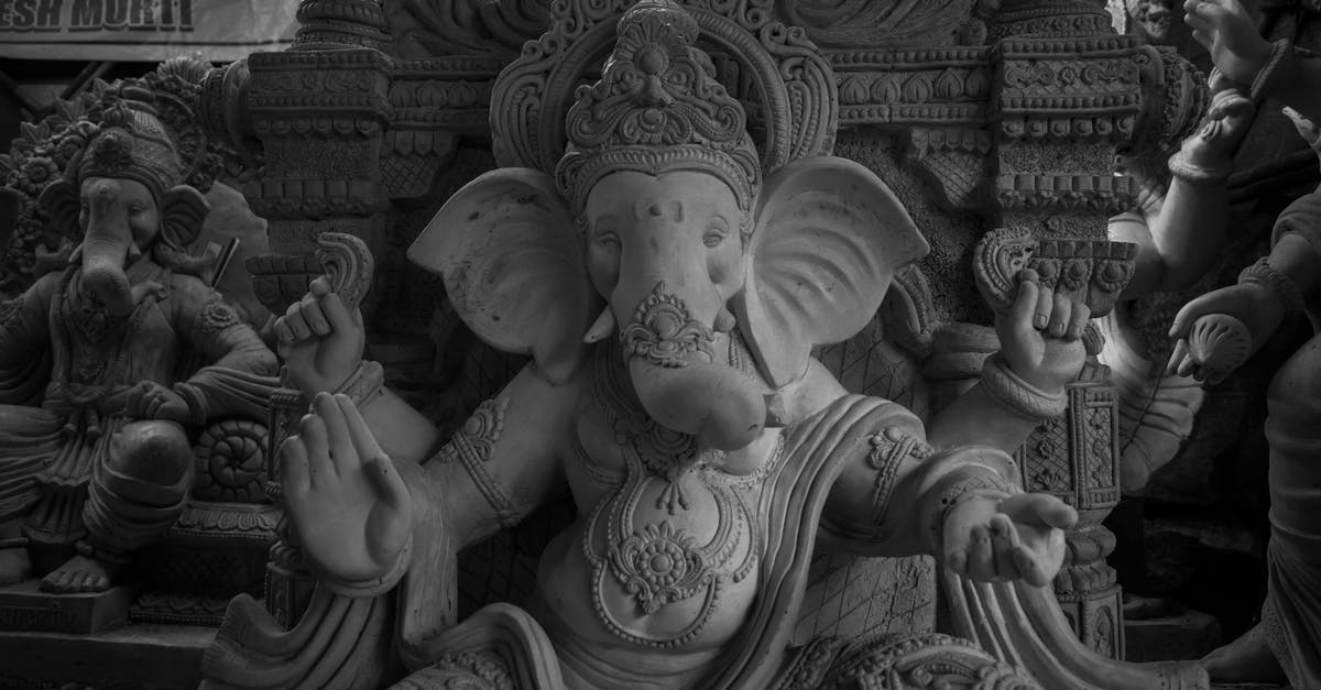 To whom is Ganesh Gaitonde telling his story in Sacred Games? - Grayscale Photo of Ganesha Statues