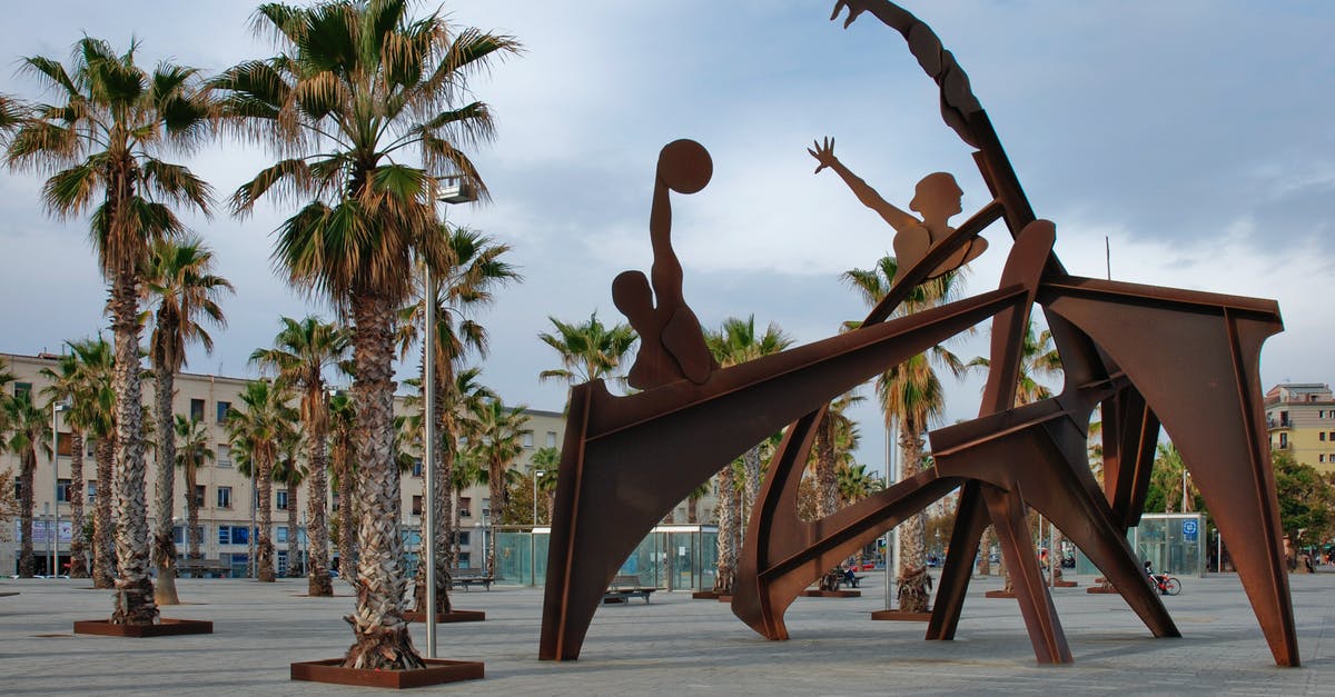 Tribute to Stan Lee in The Flash? - Brown Steel Sculpture of Sports Near Green and Brown Tree
