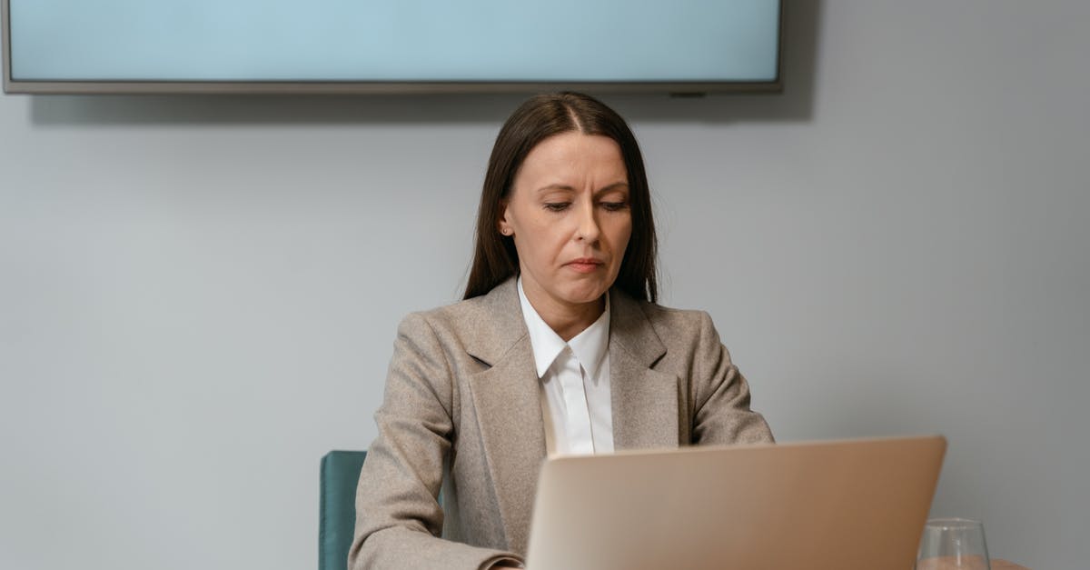 Trope where one person pretends to be multiple people working different jobs - Photograph of a Woman Working on Her Laptop