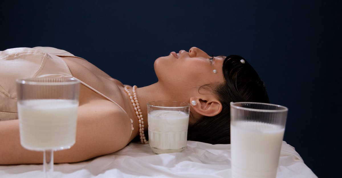 Tug could be milk and vodka? - Woman in White Tank Top Lying on Bed