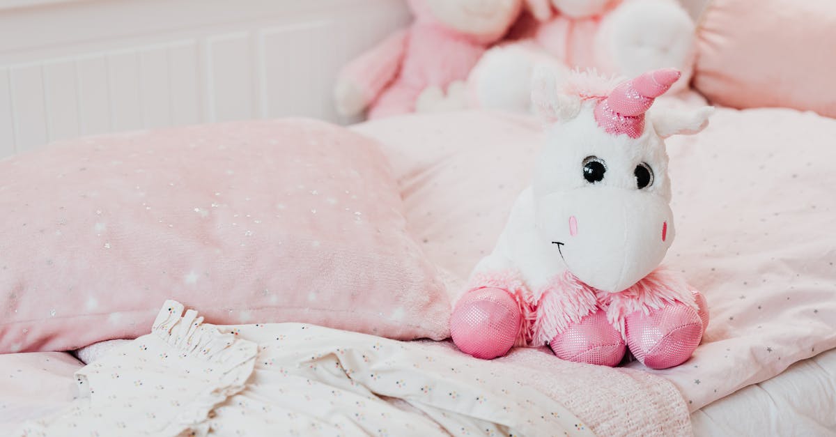 Uncle Elroy's bedroom scene? - White and Pink Unicorn Plush Toy on Bed