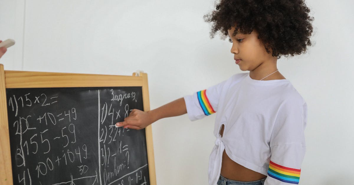 Unwritten rule that you never show a child getting seriously injured or killed? - Side view of pensive black girl pointing at mathematical example on blackboard at light room in daytime