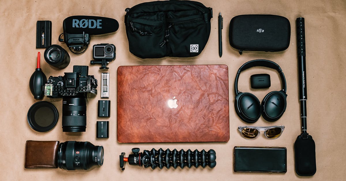 Was film actually “better” than digital media? - Overhead view of laptop and photo camera composed with headphones and other gadgets of professional photographer