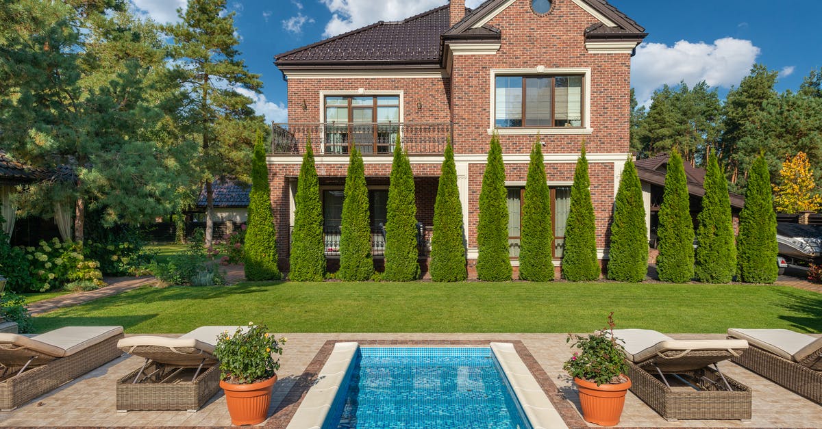 Was Terra Nova too expensive to be renewed? - Facade of brick dwell villa with green bushes on lawn and sunbeds near swimming pool