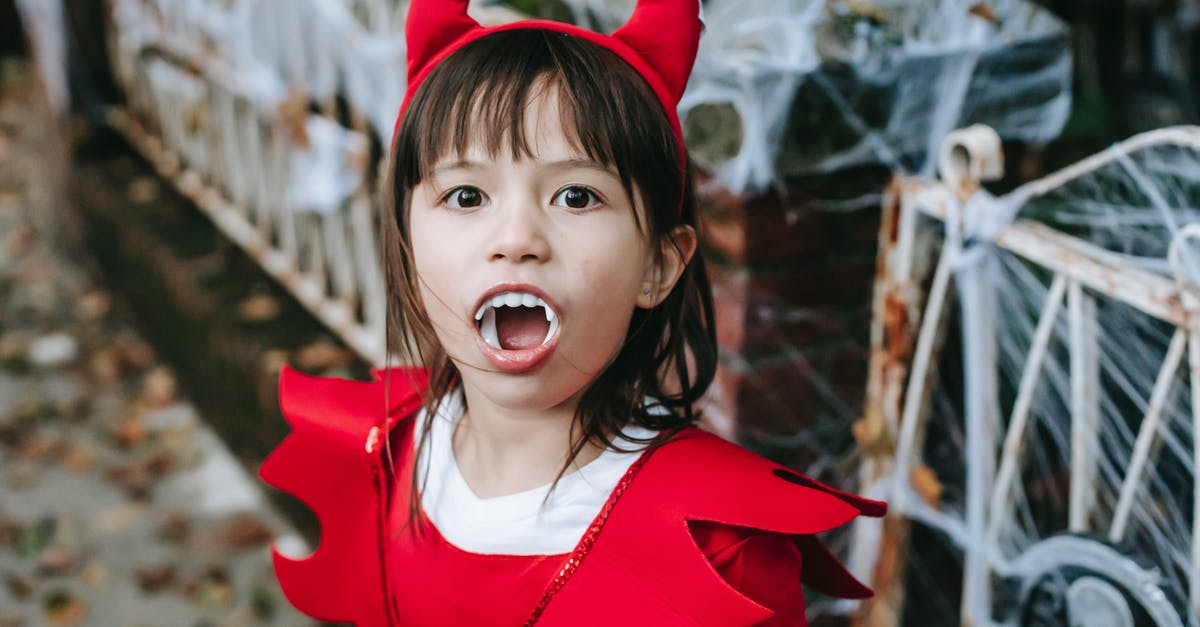 Was the creation of the little red haired girl inspired by a childhood crush? - Little girl standing in street in devil costume at Halloween
