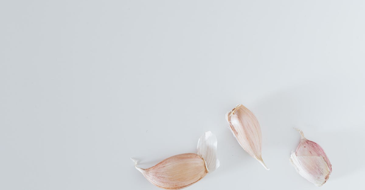Was the siege on for a whole day or over several days? - Minimalistic composition of unpeeled garlic on gray surface