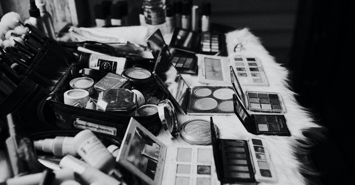 Was Thor: Ragnarok supposed to have darker tone in start of production and changed later? - Black and white high angle of assorted makeup products and tools placed on dressing table near mirror