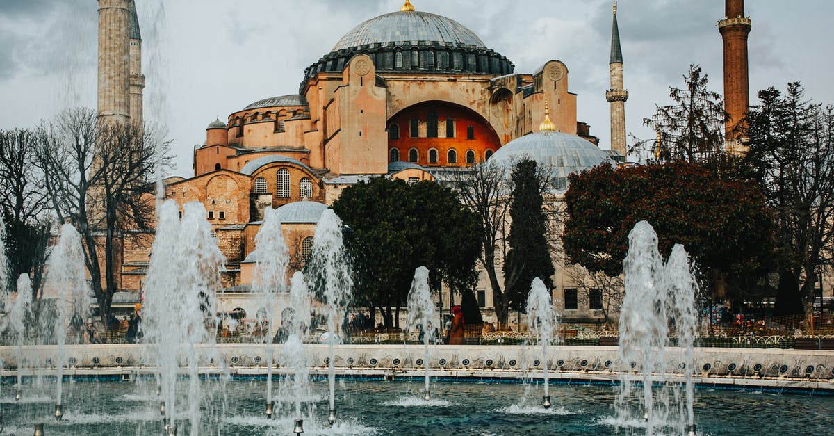 Water as a symbol in Fatal Attraction - Fountains in square near historic Holy Hagia Sophia Grand Mosque located in Istanbul against overcast sky