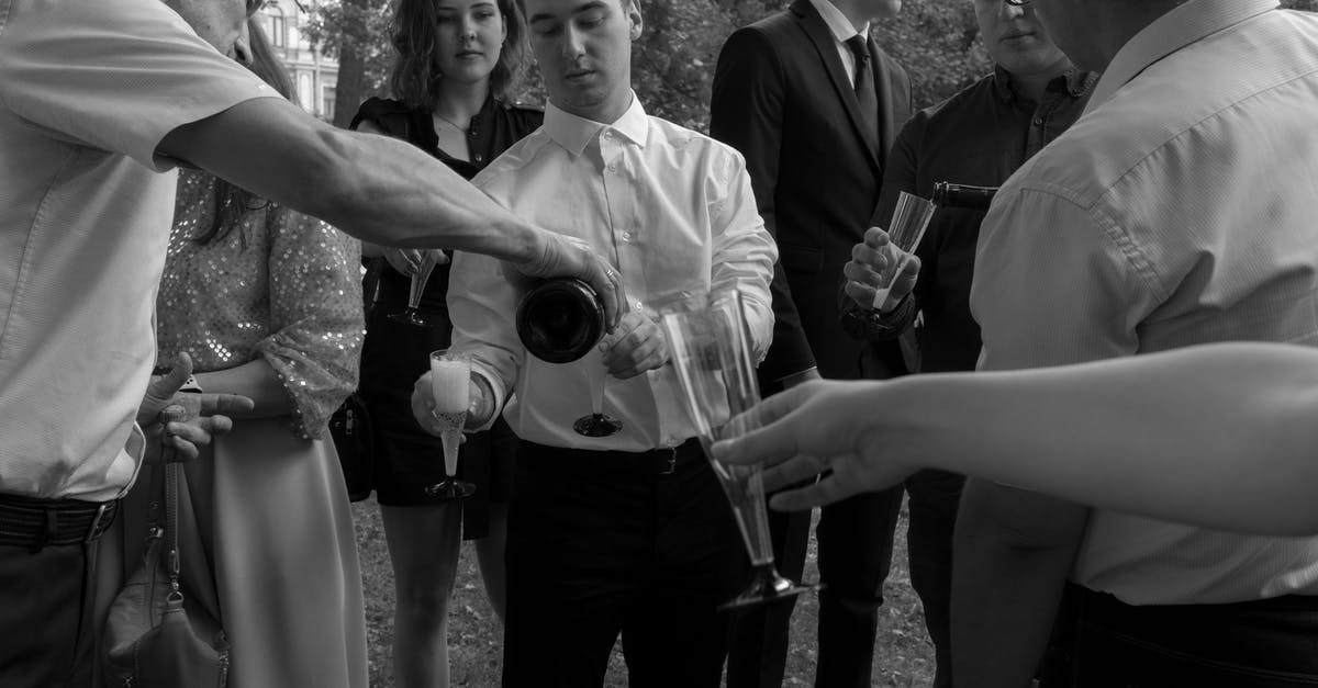 Wedding guests for Gru and Lucy - Grayscale Photo of Man in Black Suit Holding Trophy