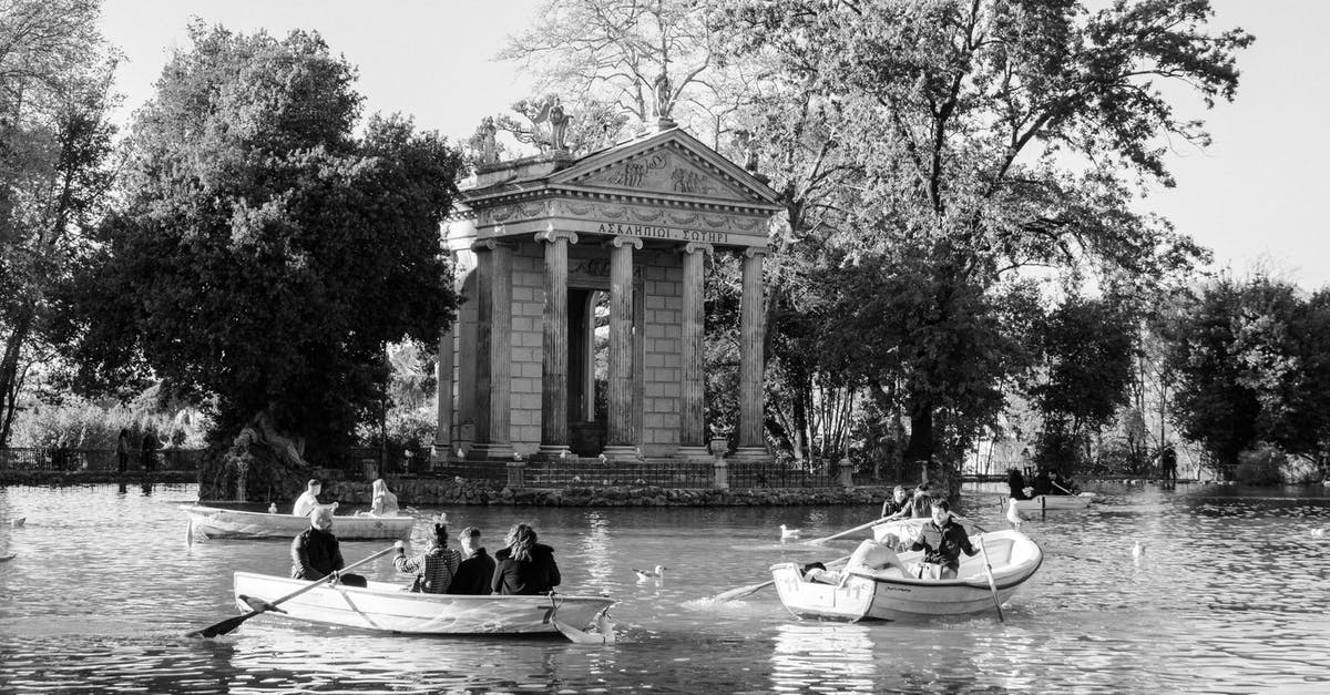 Were African people common in Rome during gladiator fights? - Grayscale Photo of People Riding on Boat on River