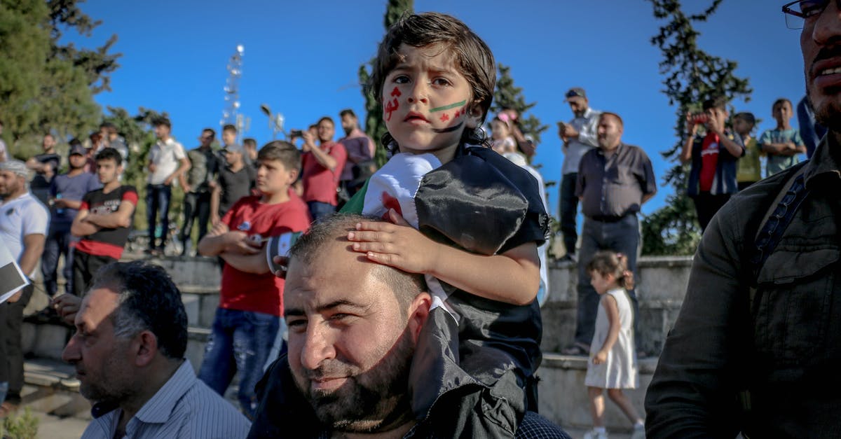 Western about a sheriff with a tin star made by children [closed] - Smiling ethnic father with daughter on shoulders during strike