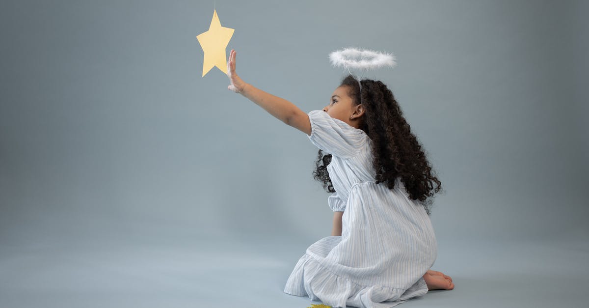 Western about a sheriff with a tin star made by children [closed] - Black girl in angel outfit touching star