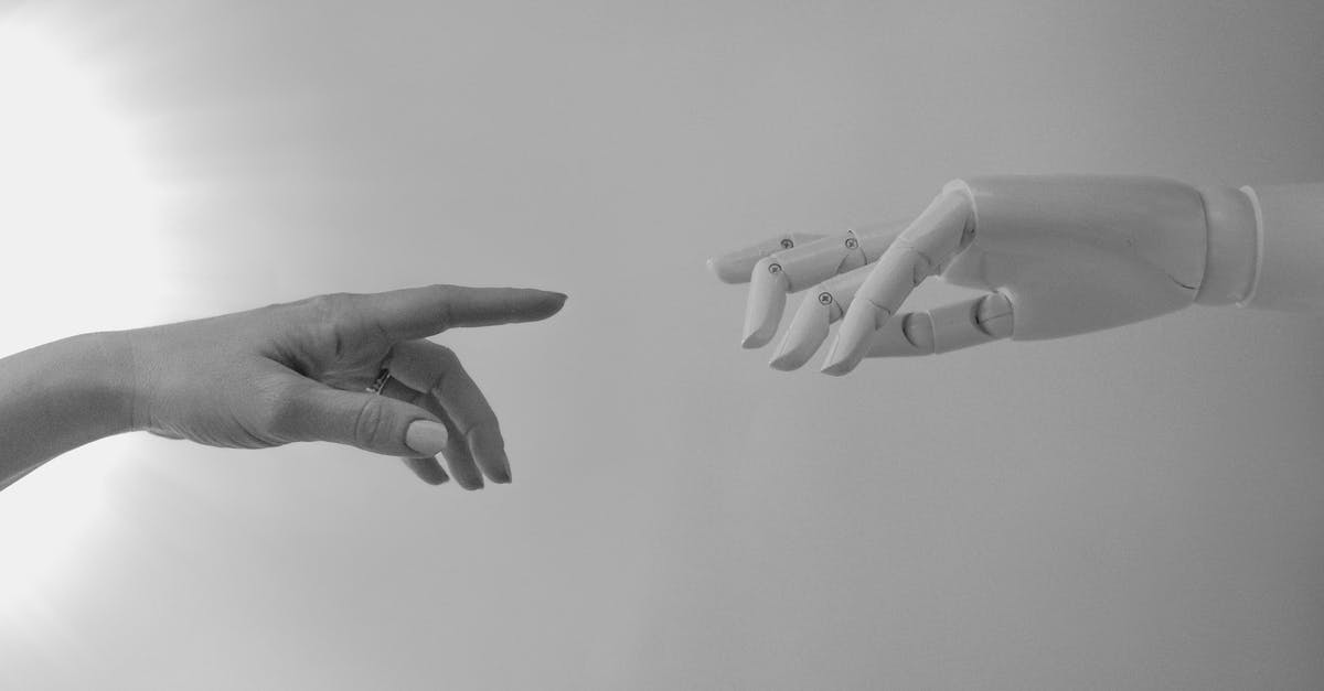 What's the connection with Back to the Future movie? - Black and White Photo of Human Hand and Robot Hand