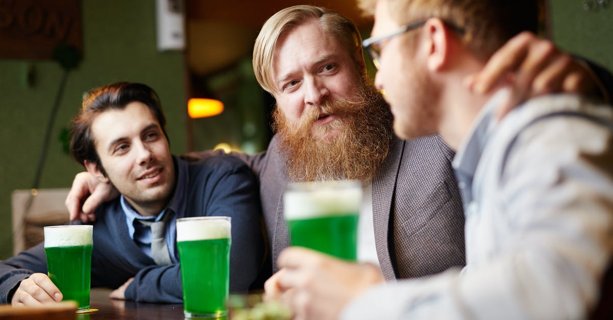 What's the meaning of "I can't get the drinks out"? - 3 Men Having a Chat over a Drink