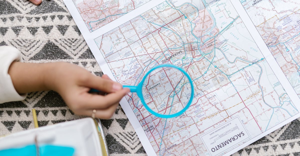 What's the name for this zoom effect where you suddenly zoom into a particular subject in a wider shot? - Person Holding Blue Magnifying Glass Over a Map