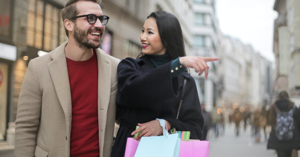 What's the point of the "unadvertised" sale in the episode "The Pie"? - From below happy stylish Asian woman in warm clothes smiling at cheerful unshaven man in glasses and pointing finger away while walking along street together in city after shopping