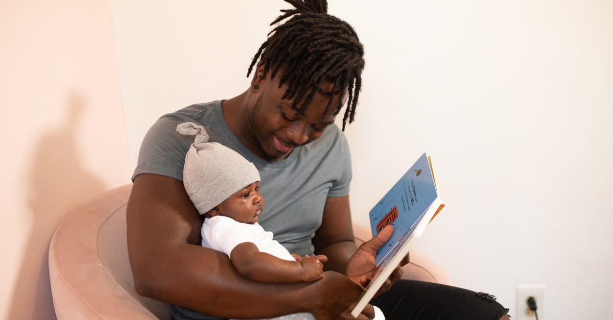 What's the significance of the book Bonnie is reading? - Photo Of Man Carrying Baby