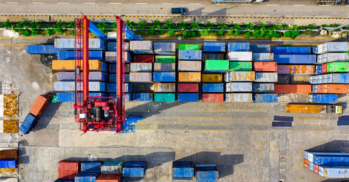 What's the significance of the trucks in these scenes? - aerial view of containers