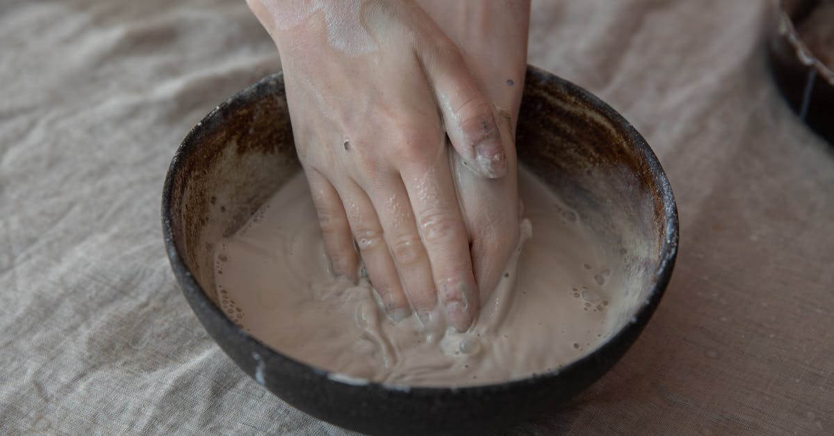 What's the term and production process for a teaser consisting of clips from the show? - From above of crop anonymous craftsperson mixing clay in round shaped bowl in workroom