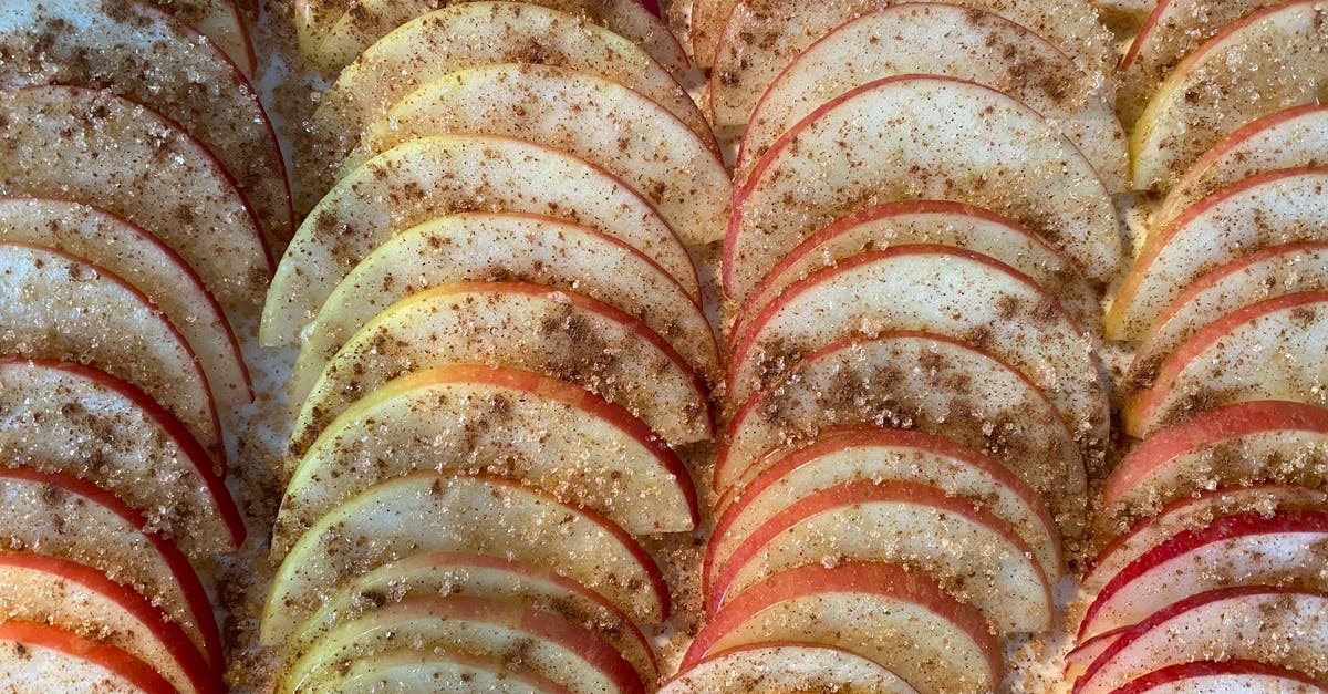 What's with apple pie at the diner? - Closeup of delicious homemade pie with rows of slices of apples covered with sugar and cinnamon