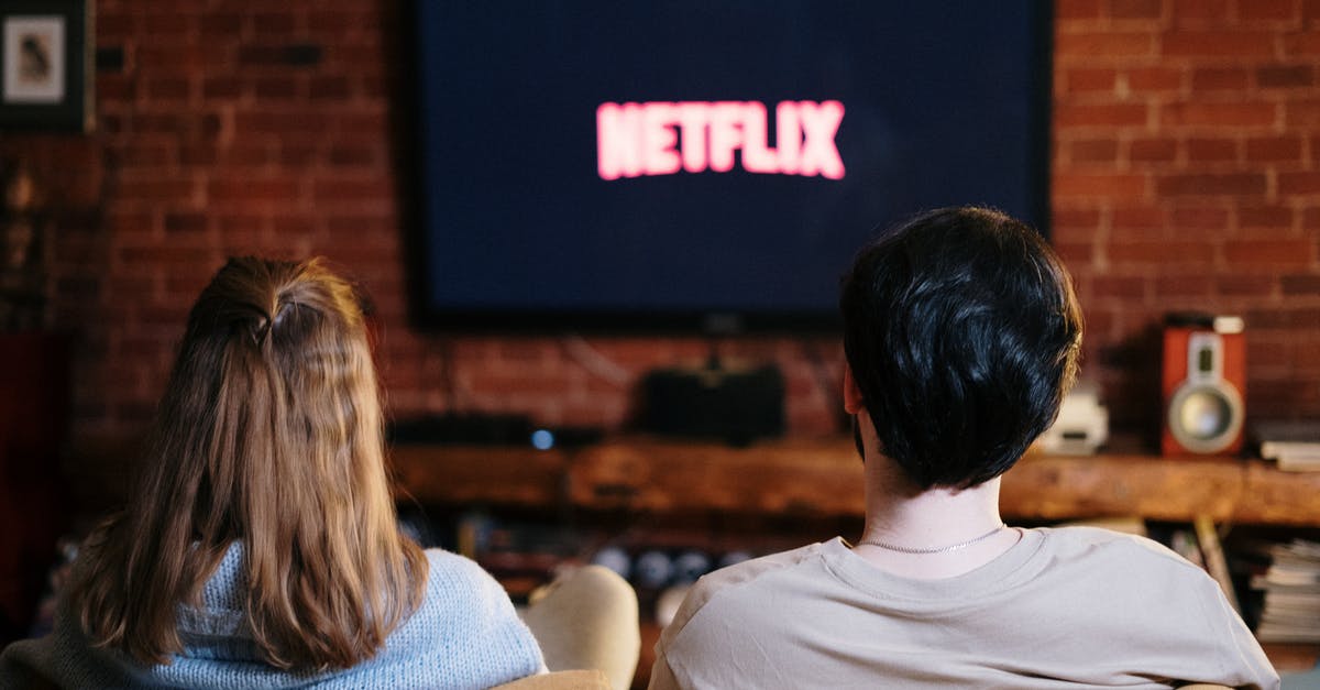 What are the awards for which Netflix original movies are eligible? - People Sitting on a Couch Watching 