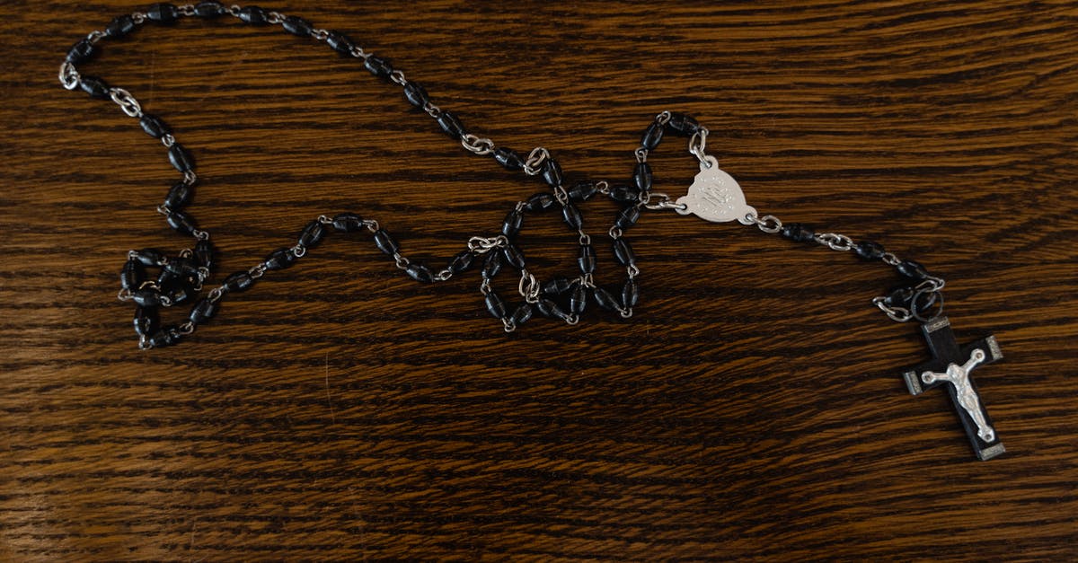 What are the references to the known myths in the movie "The killing of a sacred deer"? [closed] - Silver Chain Necklace on Brown Wooden Table