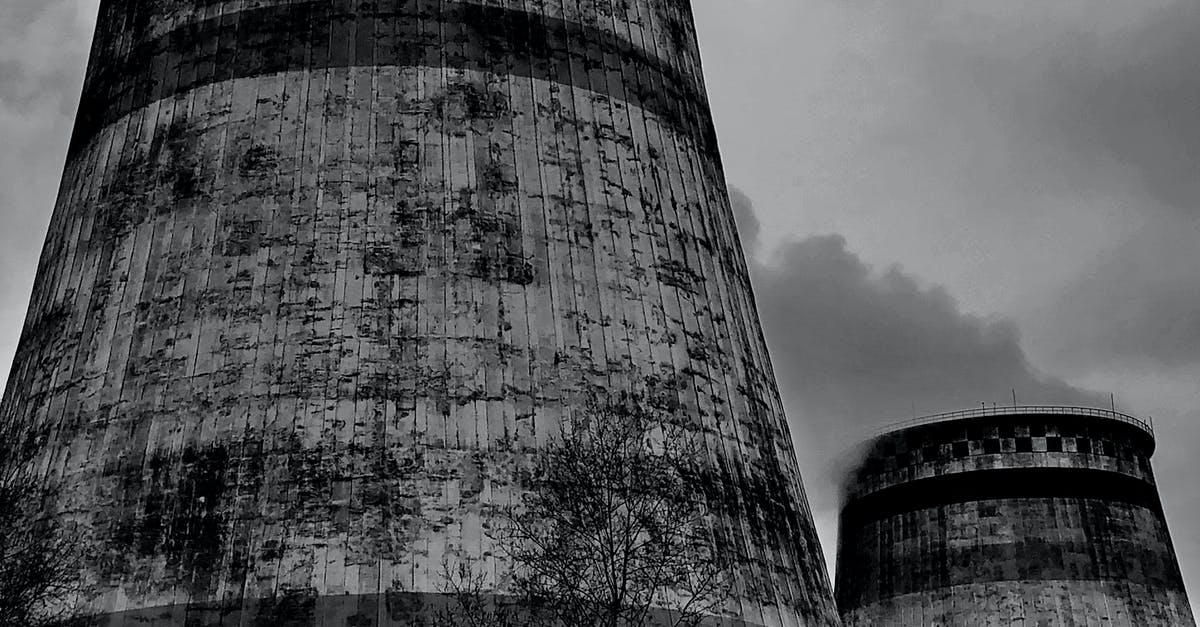 What are the younger and aged Unknowns triggering in the Power Plant? - Old draft wet cooling towers in city industrial district on cloudy sky