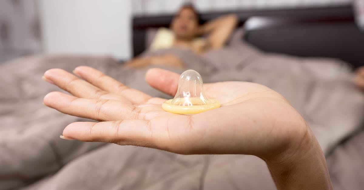 What conditions and requirements are needed to film sex scenes safely? - Close-up of Woman Holding Condom