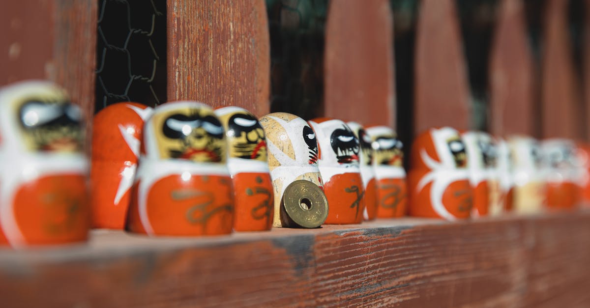 What did "The Ring" (リング, Ringu) in the original Japanese version refer to? - Daruma dolls on wooden fence