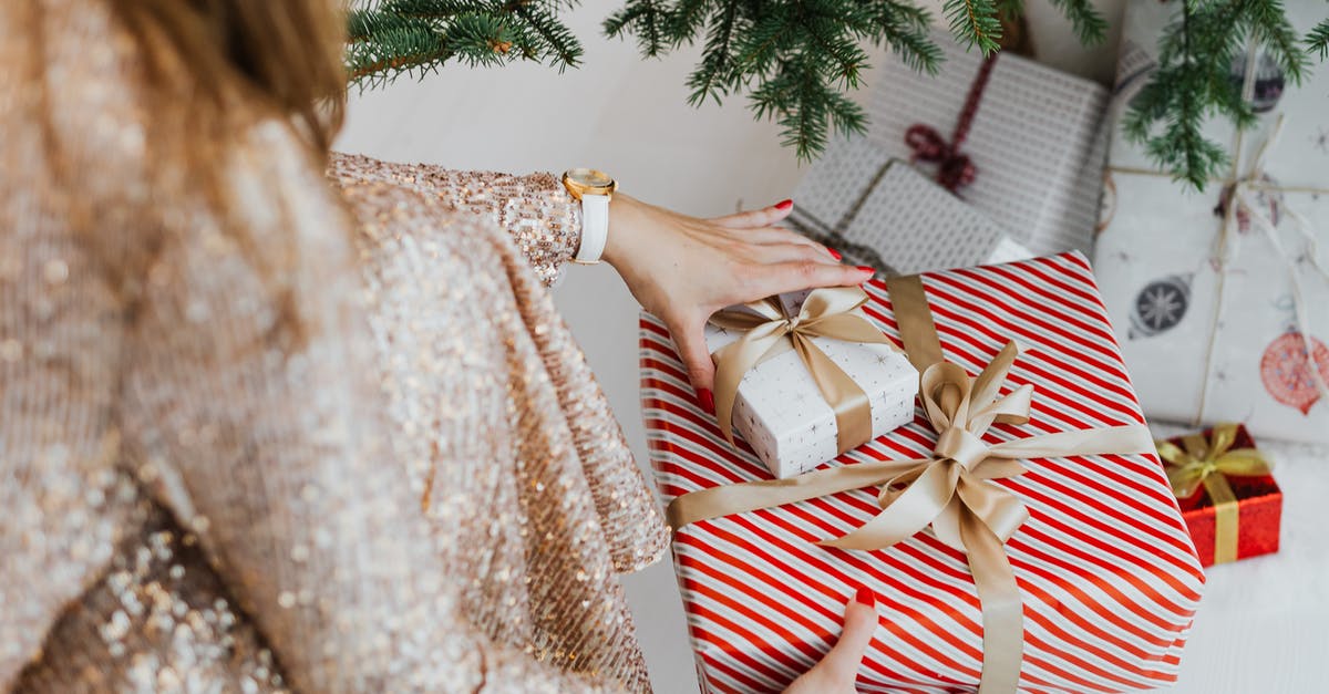 What did the gifts signify? - Woman in Beige and White Long Sleeve Dress Holding Red and White Striped Textile