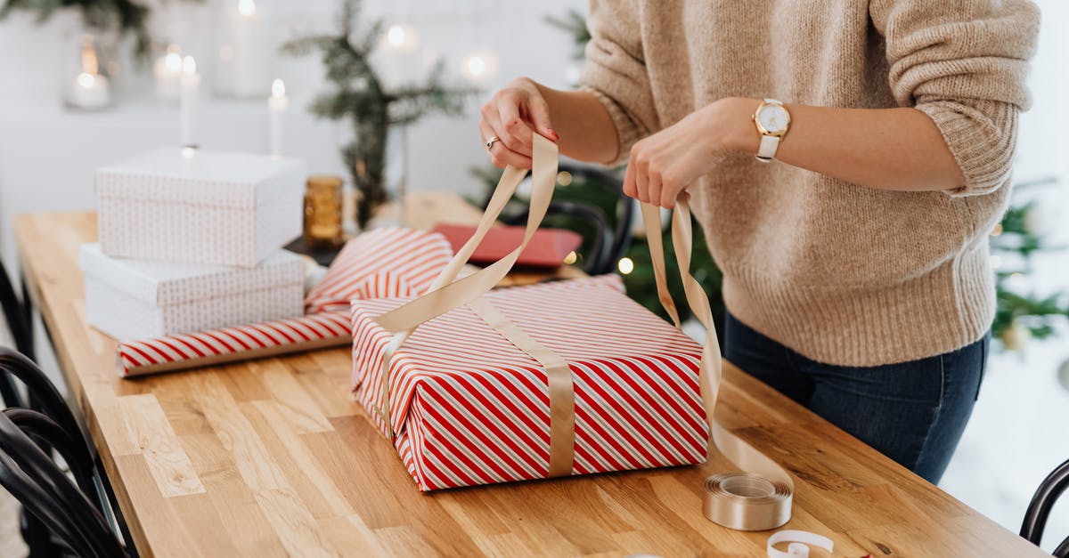 What did the gifts signify? - Person Holding White and Red Striped Tote Bag