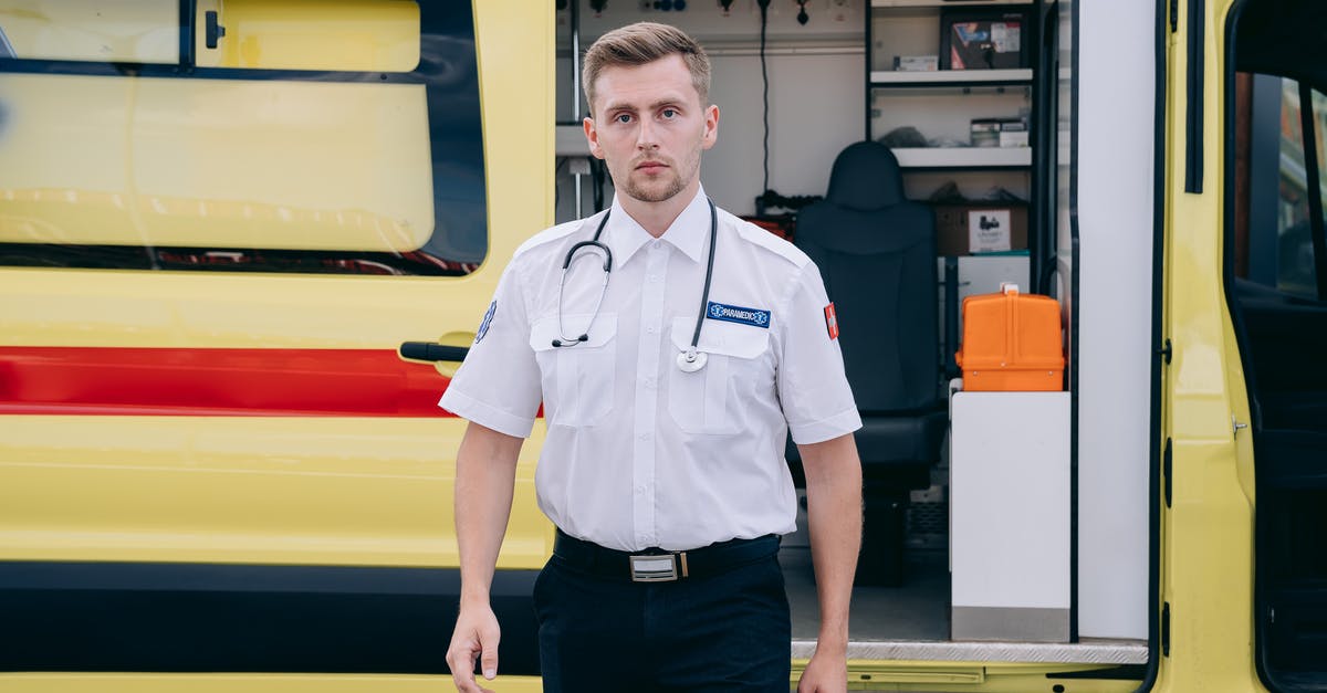 What do sitcom car rigs look like without effects? - Paramedic Standing Beside an Ambulance