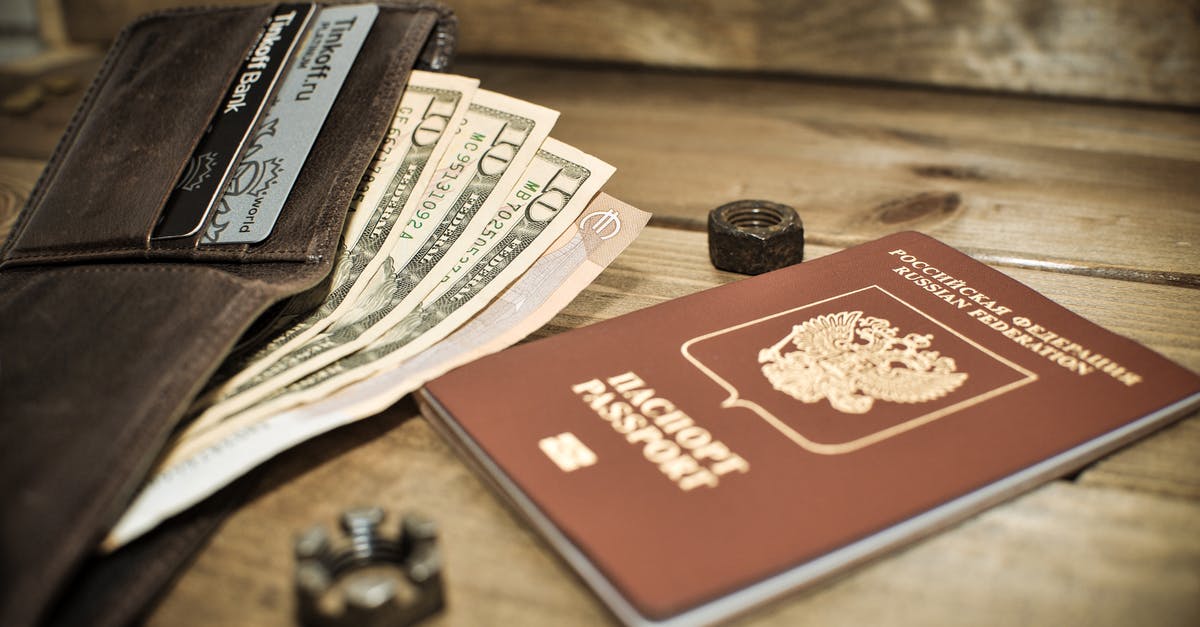 What does Helsinki say to Oslo in Russian in Money Heist, at the end of S01E12? - Photo of a Brown Passport Beside a Wallet with Dollar Bills
