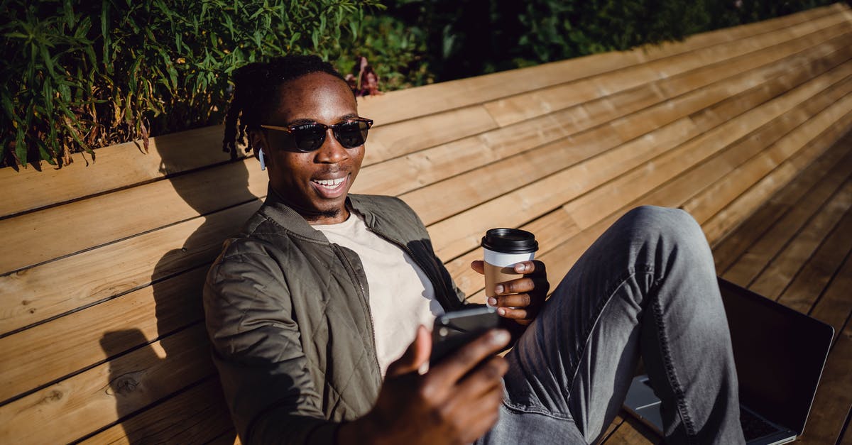 What does Paul Avery tell the coffee guy after the coffee guy calls him a "drunken reprobate"? - Cheerful young black man having video conversation via smartphone during coffee break in park