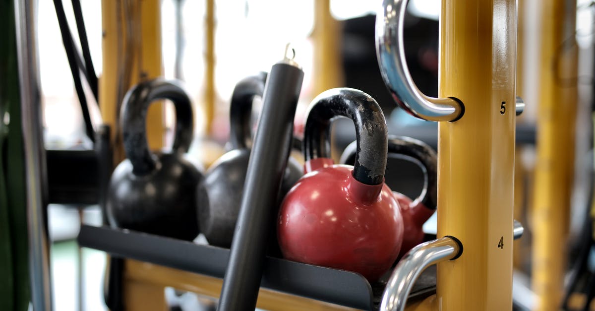 What does the line 'Your weight and your fate right here..' mean? - Set of different kettlebells placed in row on metal platform on modern fitness equipment in sport center