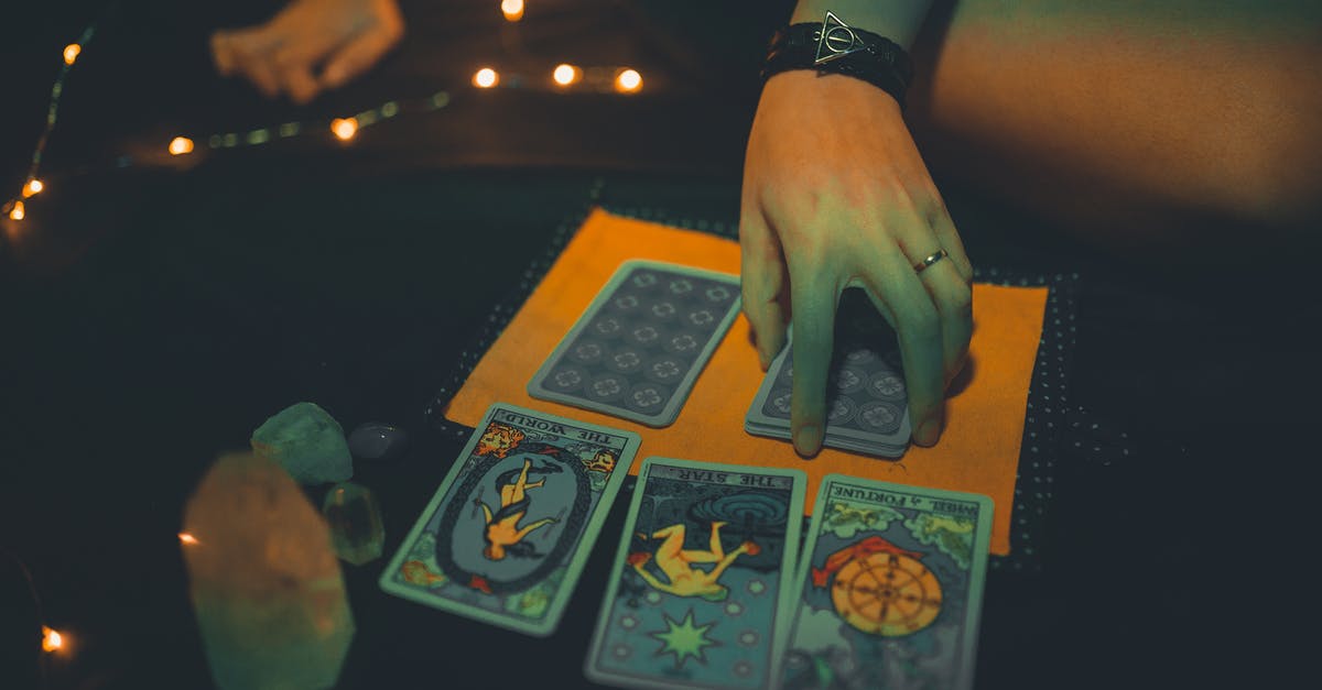 What does the woman from the future mean when she says she's "in insurance"? - Crop female future teller with tarot cards on table