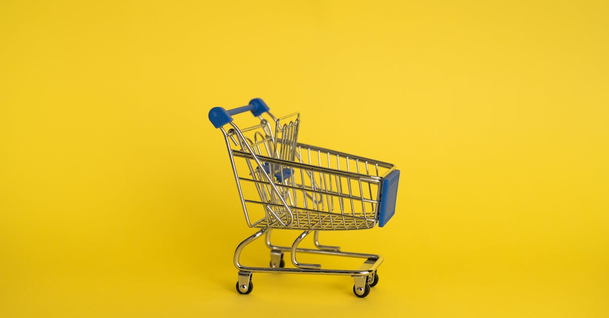 What does the yellow speech contain? Also the truth? - Isolated shining metal shopping trolley without anything located separately on yellow background