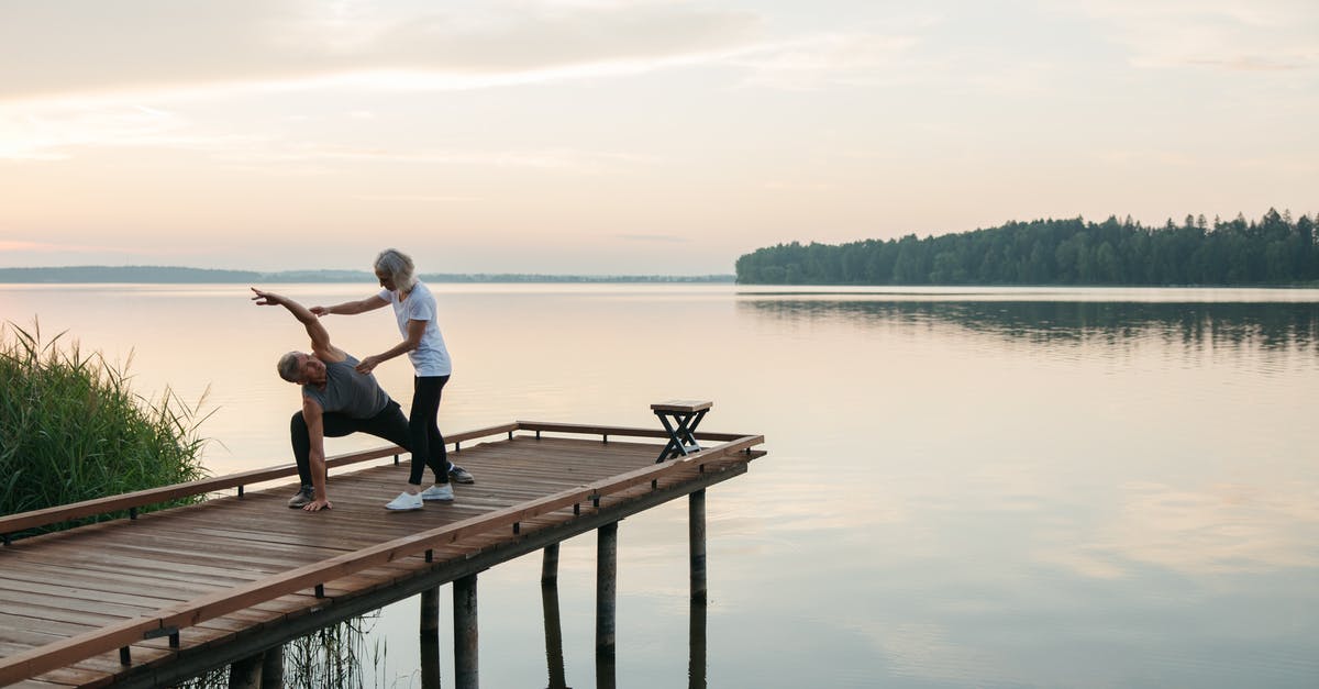 What exactly is bicameral mind? - Man and Woman Sitting on Wooden Dock