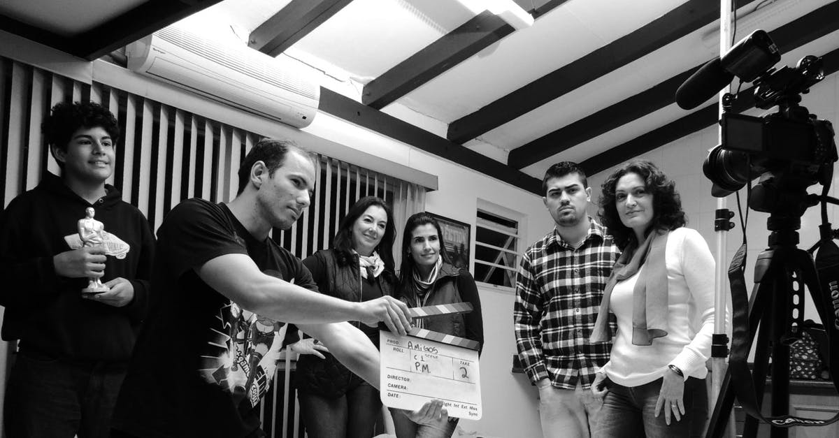 What exactly is the director trying to express in the scene where Mia and Sebastian are flying through the stars? - Grayscale Photo of Group of People in Recording Session