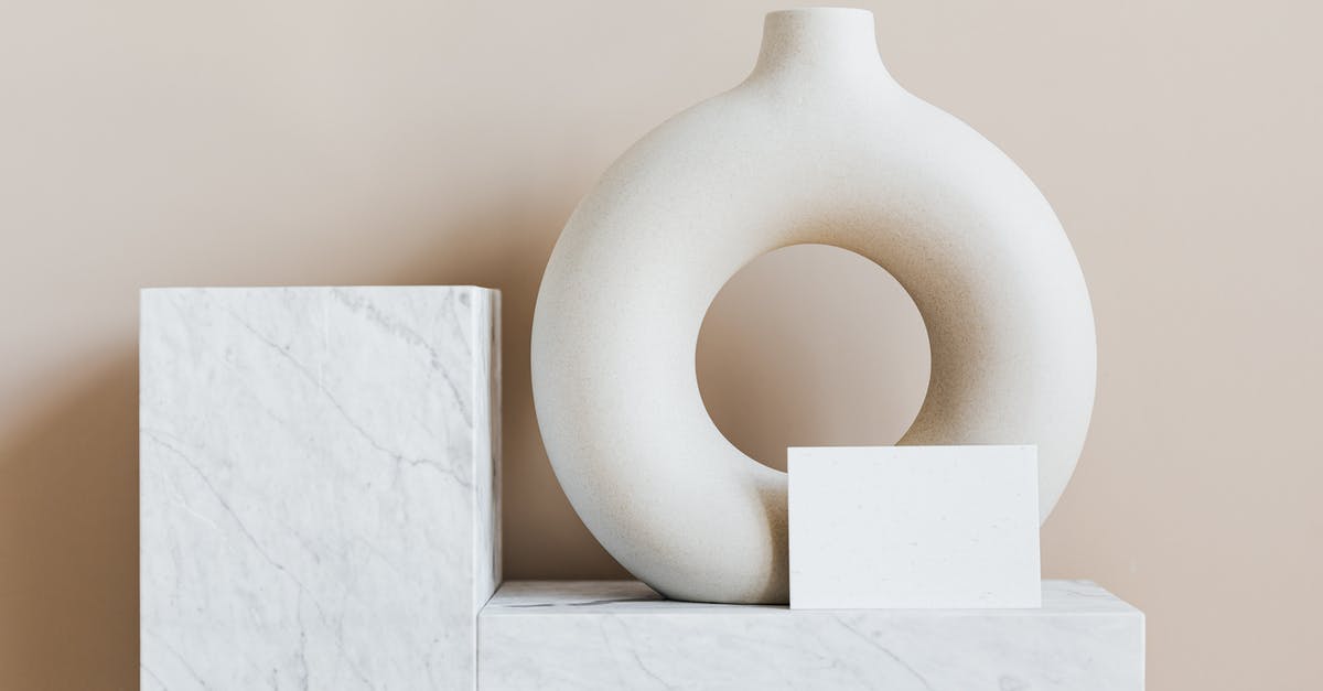 What happened to Hector Mendoza in House of Cards? - Composition of creative white ceramic vase in ring shape with empty postcard placed on white marble shelf against beige wall as home decoration elements or art objects