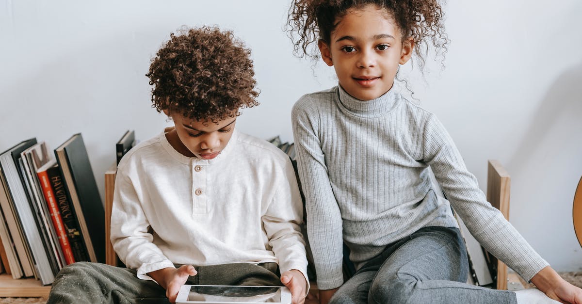 What happened to Ralph's game while he was inside the Internet? - Cheerful black girl with brother browsing tablet