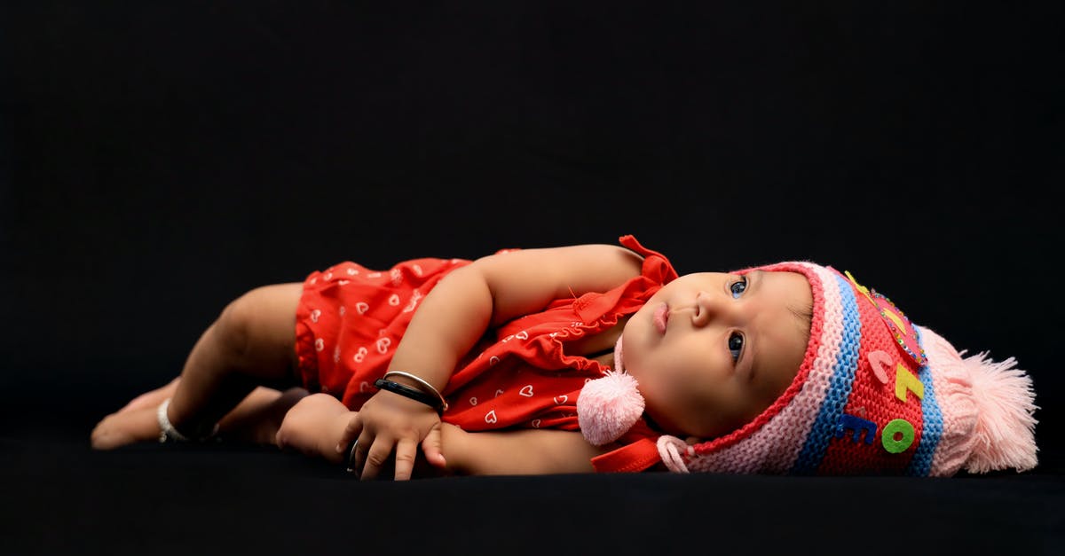 What happened to the infant near the end of "Border"? - Baby in Red Shirt Lying on Black Textile