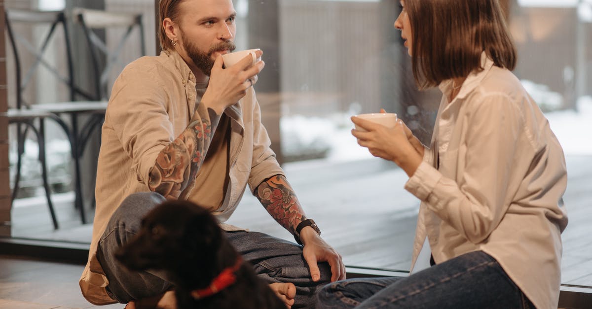 What happened to the other dog? - Couple Drinking Coffee Sitting Beside a Dog